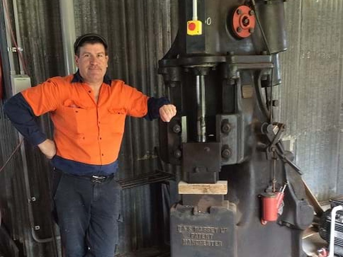Martin beside the hundredweight Massey power hammer