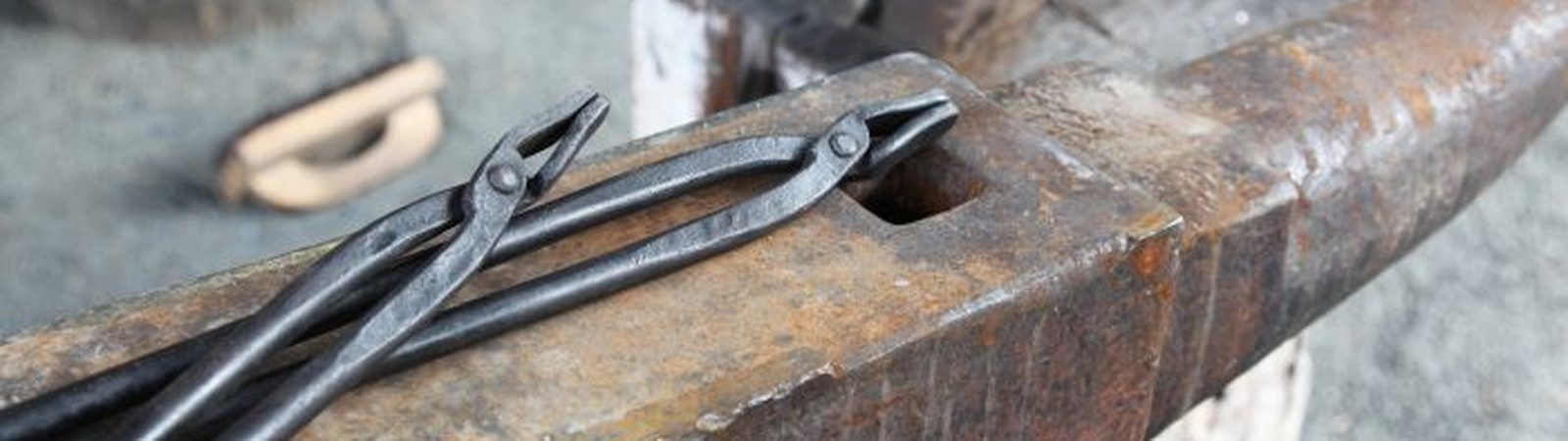 Hand-forged tongs on the anvil